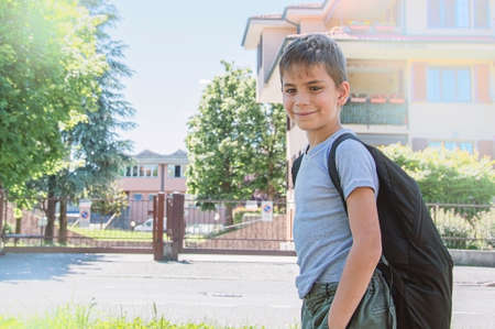 The schoolboy comes back to school. He has smile. Behind shoulders at the pupil a satchel.の写真素材