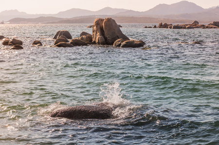 sunset sea with rocks and mountains in the background.beautiful sea.Sardinia