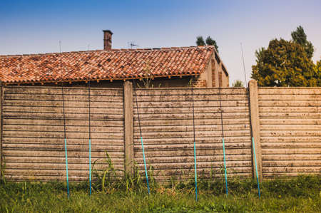 A few fishing rods leaning against the old fence.preparation for the competitionの写真素材