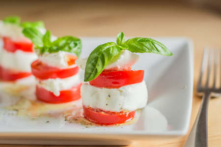 Caprese salad with mozarella cheese, tomatoes and basil.の写真素材