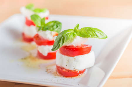 Caprese salad with mozarella cheese, tomatoes and basil.の写真素材