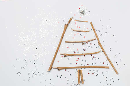 christmas tree made of sticks and decorations on a white background.Flat lay,christmas card,top viewの写真素材