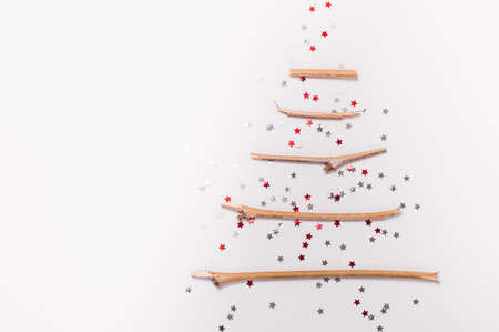 christmas tree made of sticks and decorations on a white background.Flat lay,christmas card,top viewの写真素材