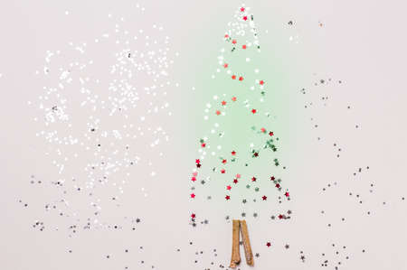 christmas tree made of sticks and decorations on a pink background.Flat lay,christmas card,top viewの写真素材