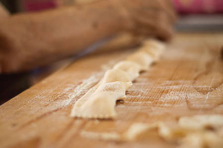 Fresh italian ravioli pasta on wood backgroundの写真素材