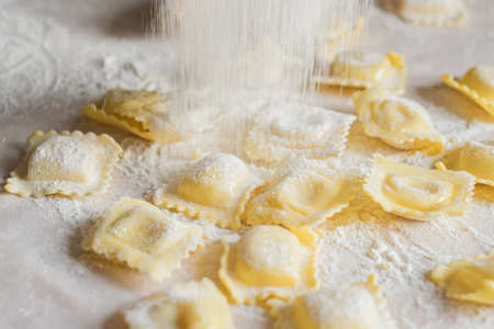Fresh ravioli pasta is sprinkled with flourの写真素材