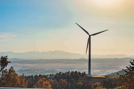 Power of wind turbine generating electricity clean energy with blue background on the sky.Global ecology.Clean energy concept save the world.Sunsetの写真素材