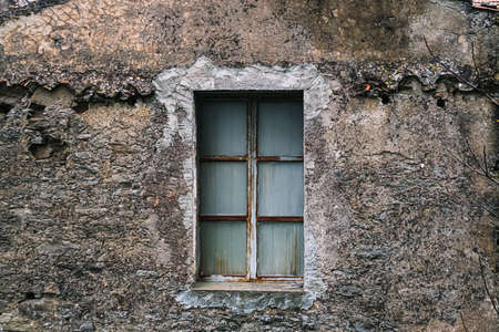 Old window with wooden frame and stone wall in Italy. Backgroundの写真素材