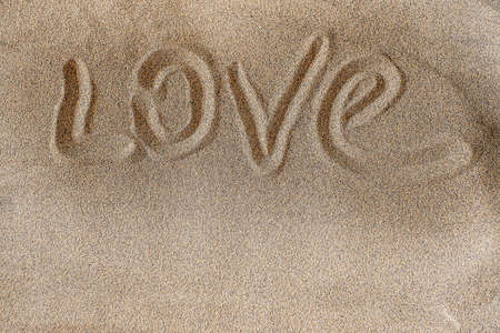 Love. Words written in beach sand background. Copy spaceの写真素材