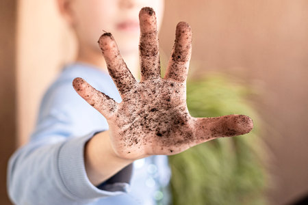 Close up child hand is dirty in the soilの写真素材