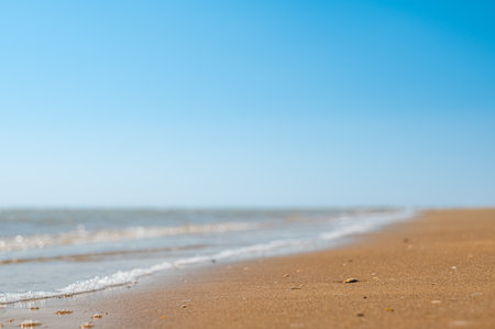 Closeup of sand on beach and blue summer sky. Panoramic beach landscape. Empty tropical beach and seascape.の写真素材