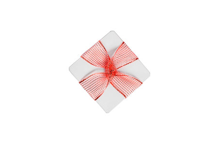 White gift box with a red bow on a white background banner, free space, top view, mockup for designの写真素材