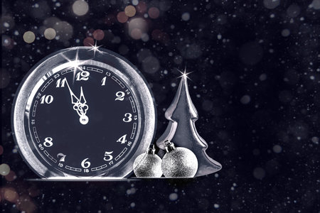 Abstract black greeting card with clock, Christmas tree and silver balls, counting last moments to New 2024 Year banner designの写真素材