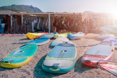 Windsurf boards on the sand at the beach. Windsurfing and active lifestyle