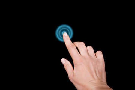 Electric blue circle highlighted by hand gesture in darknessの写真素材