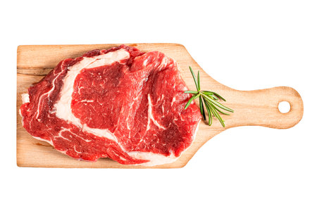 A piece of meat rests on a rustic wooden cutting boardの写真素材