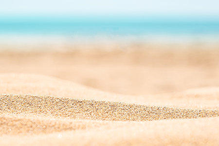 Sandy beach with horizon blue sea and sky backgroundの写真素材