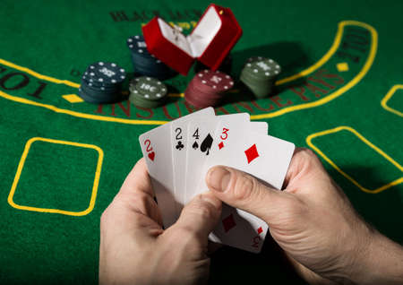 Winning combination in poker game. Cards and chips on a green cloth.