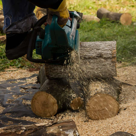 chainsaw on the background of sawn logs. firewood for the winter