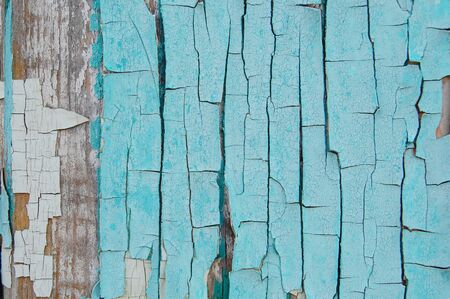 light blue cracked paint on a wooden wallの写真素材