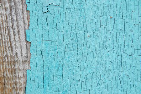 light blue cracked paint on a wooden wall