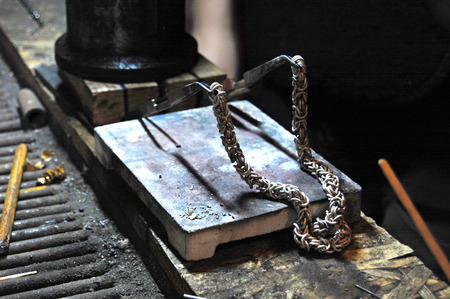 jeweller making silver chainの写真素材