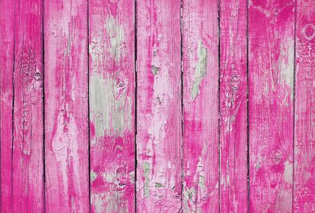 pink old wooden fence. wood palisade background. planks textureの写真素材