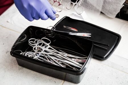 Sterile medical instruments of a surgeon doctor folded in a black box. Set of a veterinarian surgeon for sterilization and other animal operations.の写真素材