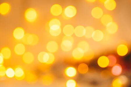 Christmas background. Festive golden abstract background with bokeh defocused lights and starsの写真素材
