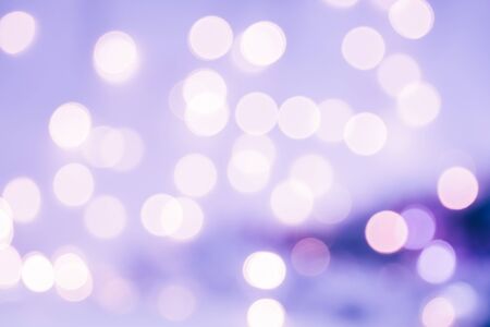 Christmas background. Festive violet abstract background with bokeh defocused lights and stars