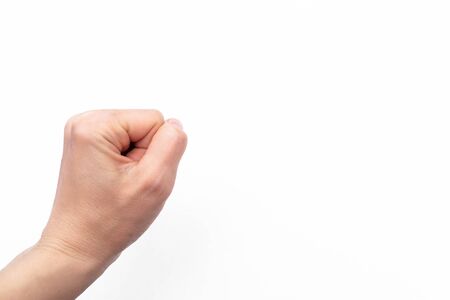 fisted tight female hand on a white backgroundの写真素材