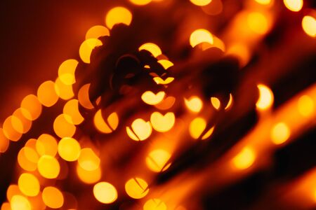 silhouette of the symbol of love - hearts against the bright orange blurred lights, valentine cardの写真素材