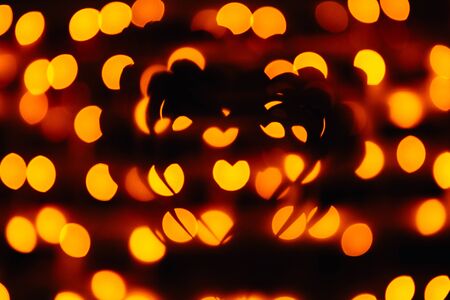 silhouette of the symbol of love - hearts against the bright orange blurred lights, valentine cardの写真素材
