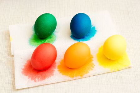 The stage of drying colored Easter eggs after painting process in the glasses. Home decorations for...