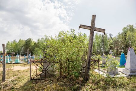 An old cemetery with tombstones and large wooden crosses. Christian burials. Western Belarus.の写真素材