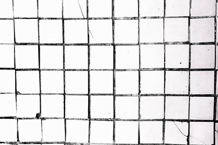 Sloppy white tiles with black seams. Minimalistic background. Abstract art.の写真素材
