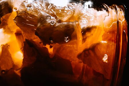 Lemon sliced in small pieces in honey shot close-up. A juicy, bright and contrasting photo can be an...