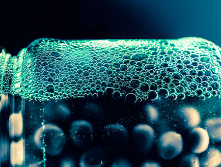 Jar with peas and foamed syrup. Harvesting for the winter. Harvest year and preservation of excess. Futuristic look evoking vivid emotions. Abstract wallpaper for kitchen dining room interior design.の写真素材