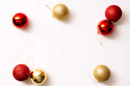 Christmas tree toys isolated on a white background. New year glitter balls red and gold color. Festive banner with place for text in fashion style. Close-up.の写真素材