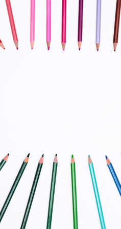 Frame of colored pencils isolated on white background by two side with free place for text. Banner...