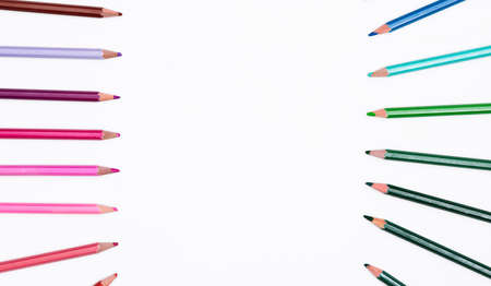 Frame of colored pencils isolated on white background by two side with free place for text. Banner with art stationery of the creative development and education of children and adults.の写真素材