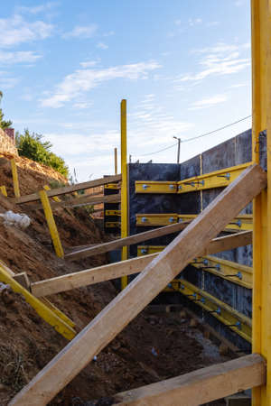 The construction of a retaining wall or counterfort, formwork, reinforced, preparation to pour concrete, construction site. Improvement of the territory. Preventive measures against landslide.の写真素材