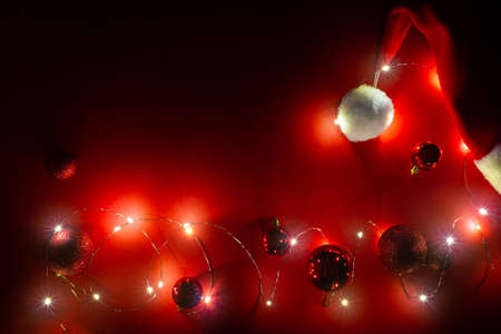 New year red banner with Santa hat, garland and christmas glitter balls. BDSM entertainment....