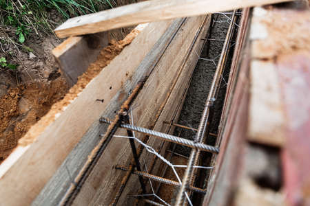 Timber formwork with metal reinforcement for pouring concrete and creating a solid foundation for a...