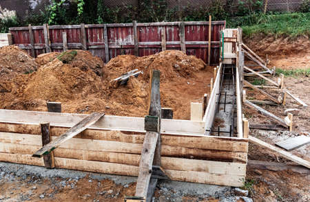 Timber formwork with metal reinforcement for pouring concrete and creating a solid foundation for a...