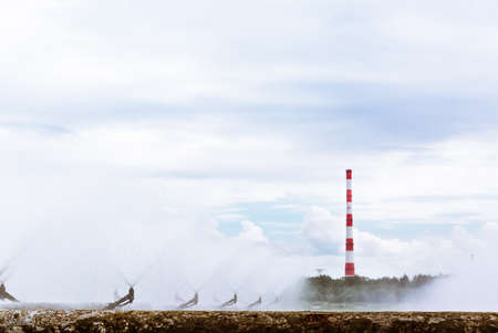 Combined heat and power plant and a lake with cooling fountains. CHP for the production and supply of the city's population with electricity and hot central water supply. Technology and nature.の写真素材