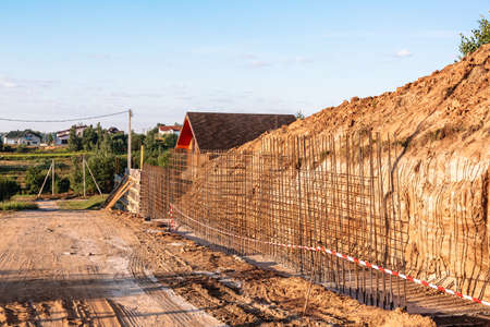 The construction of a retaining wall or counterfort, formwork, reinforced, preparation to pour concrete, construction site. Improvement of the territory. Preventive measures against landslide.の写真素材