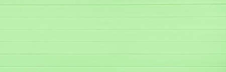 Green wooden texture background. Copy space, text place. Wood finish material shop. Natural banner. Painted plank timber. Wall lining. Rustic mockup. Indoor interior. Horizontal lines. Spring color.の写真素材