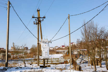 Electric transformer box on a village background. Electricity supply to the settlement. Power...