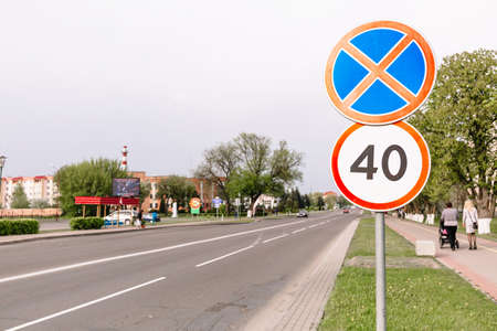 The sign of the maximum speed limit and sign prohibiting the stop on city background. Forty kilometers or miles per hour sign limitation sign. Driving school. Education course. Traffic laws. Street.の写真素材